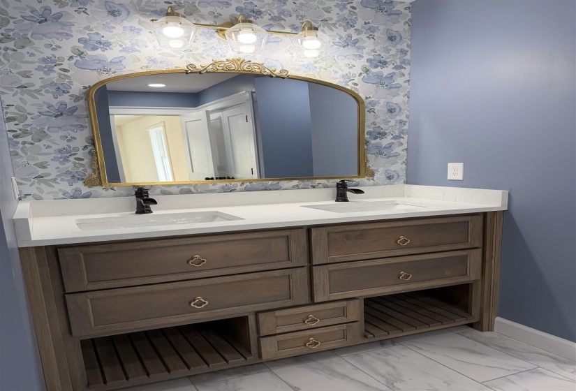 Dual vanity with white countertop and integrated sinks, complemented by matte black faucets