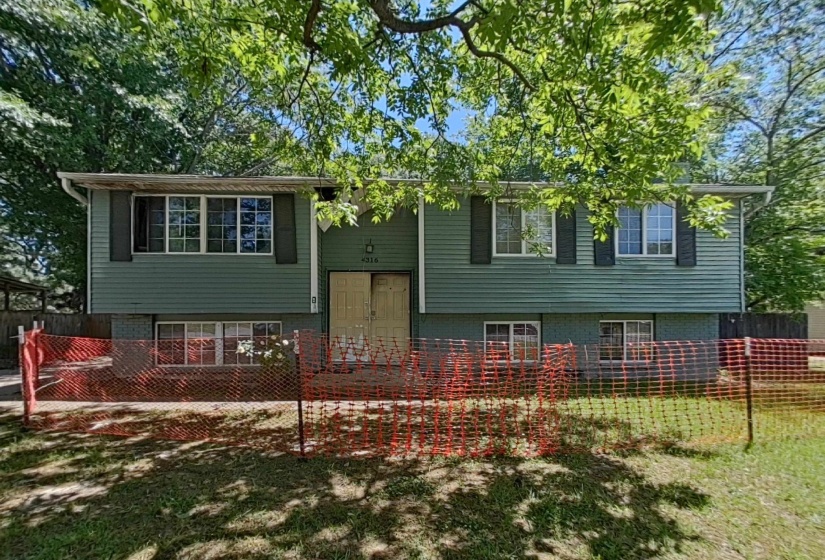 Two-story residence featuring green horizontal siding