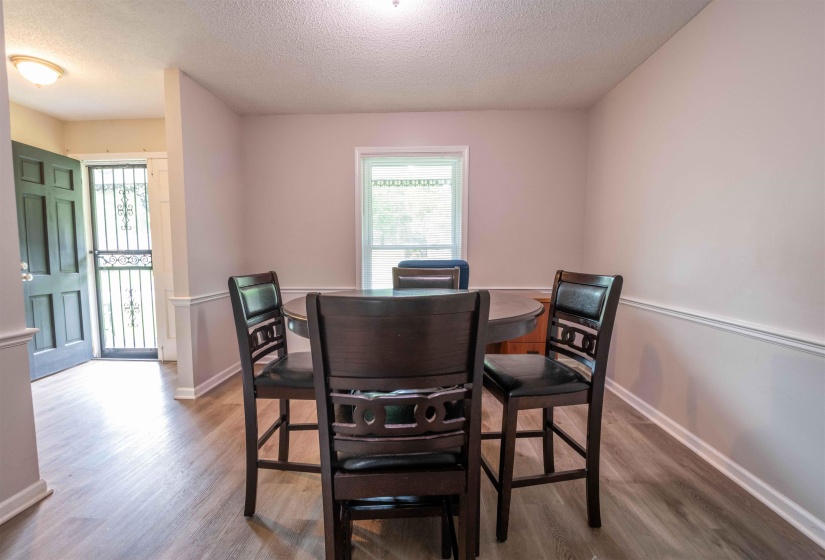 Dining area with wood-finish flooring and a single window