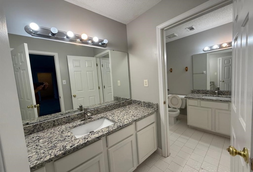 Dual vanity with granite-finish countertops, undermount sinks, and chrome faucets