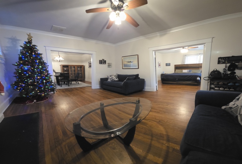 Living room featuring ornamental molding and dark wood finished floors