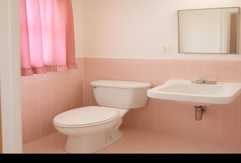 Half bath with tile walls, light tile patterned floors, and wainscoting