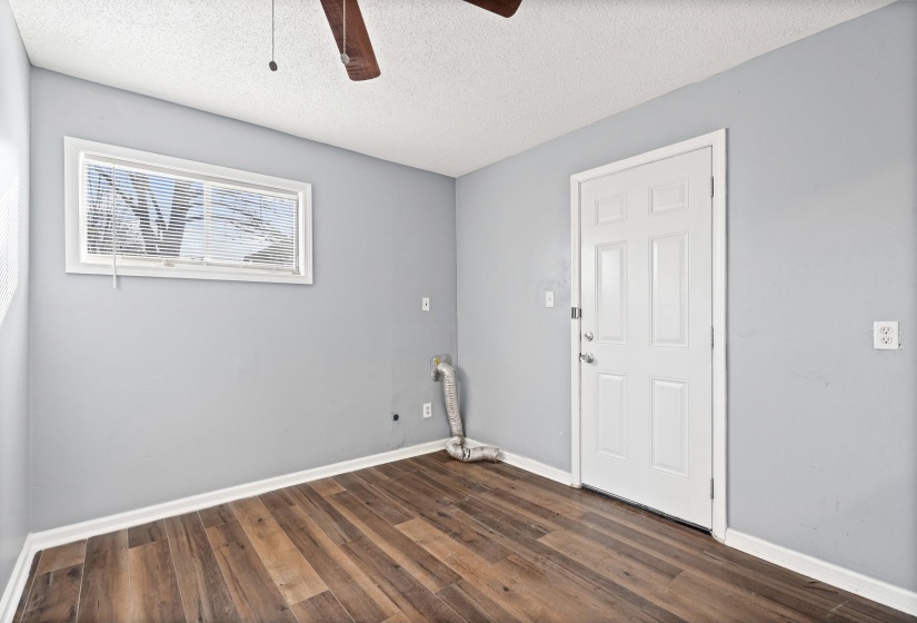 Laundry room featuring dark wood-style flooring, a textured ceiling, ceiling fan, and electric dryer hookup
