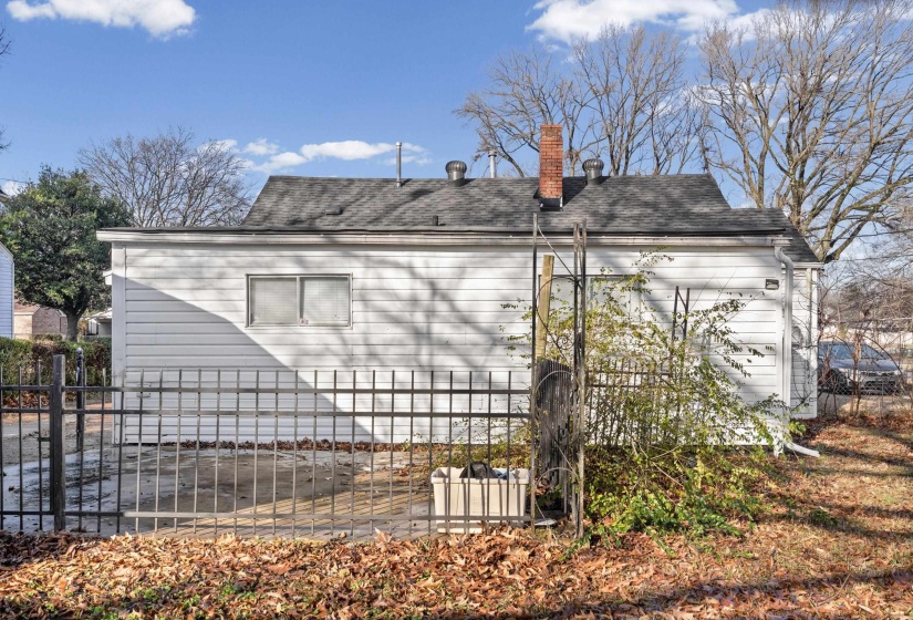 View of property exterior featuring a chimney and roof with shingles