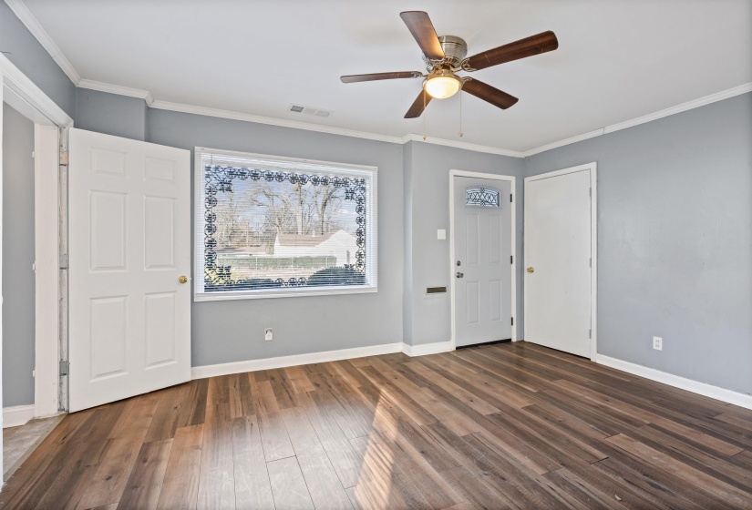Entryway featuring ornamental molding, dark wood finished floors, and a ceiling fan