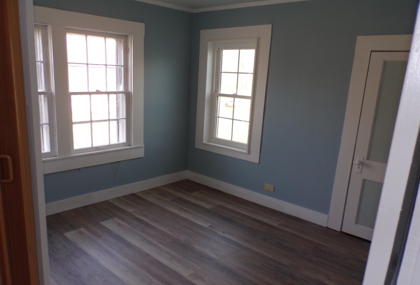 Empty room featuring baseboards and dark wood finished floors