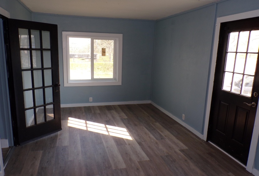 Entryway with dark wood finished floors and baseboards
