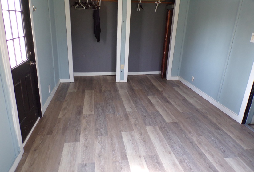 Unfurnished bedroom with baseboards and light wood-style floors