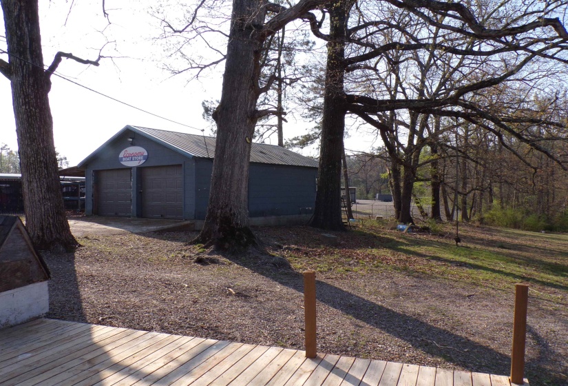 Deck featuring a garage and an outbuilding