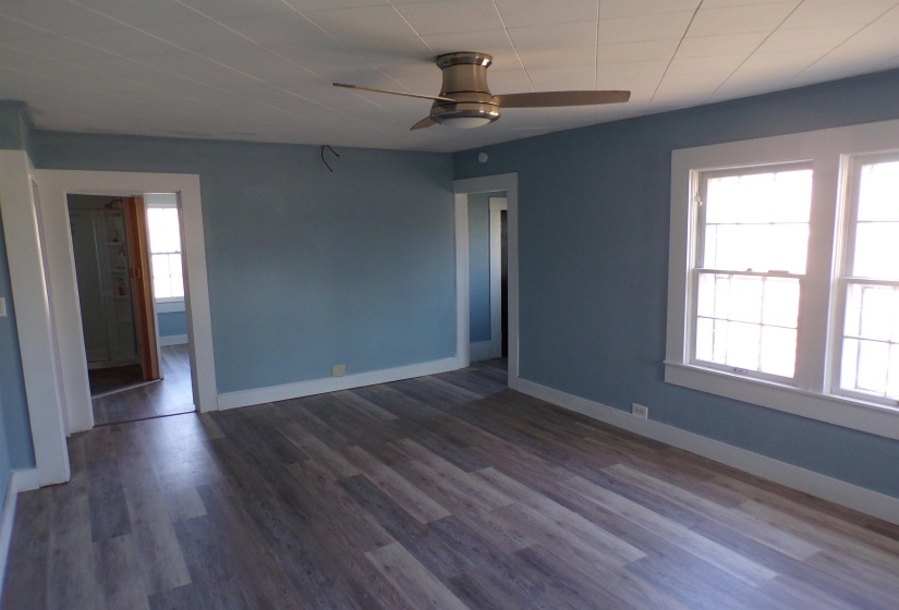 Unfurnished room with ceiling fan and dark wood-style floors