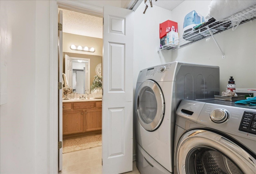 Laundry area with wire shelving, light beige wall paint, and a white ceiling