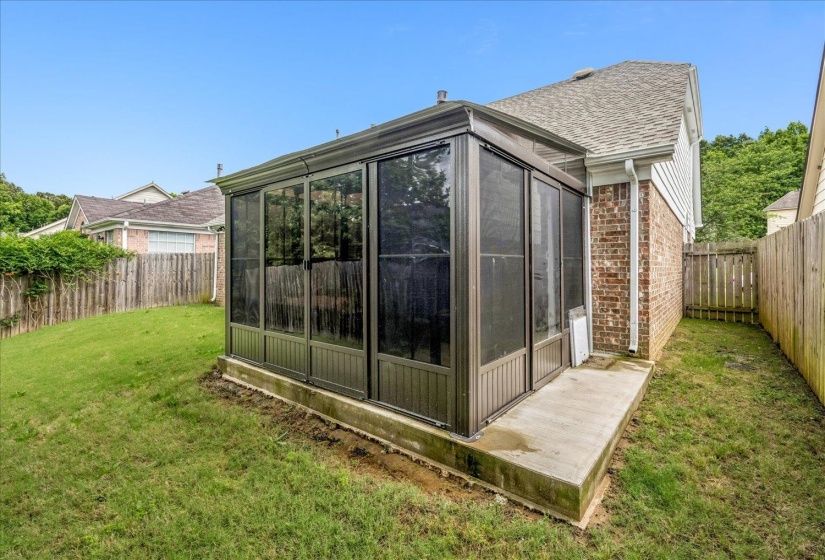 Screened patio addition with a concrete foundation and perimeter, featuring a shingled roofline