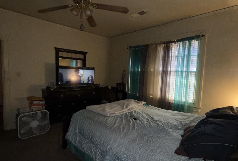 Room featuring a ceiling fan with integrated lighting, a window with blinds, and light-toned wall finishes