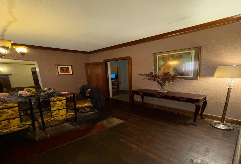 Dark wood-finish flooring with coordinating wood trim and door frames