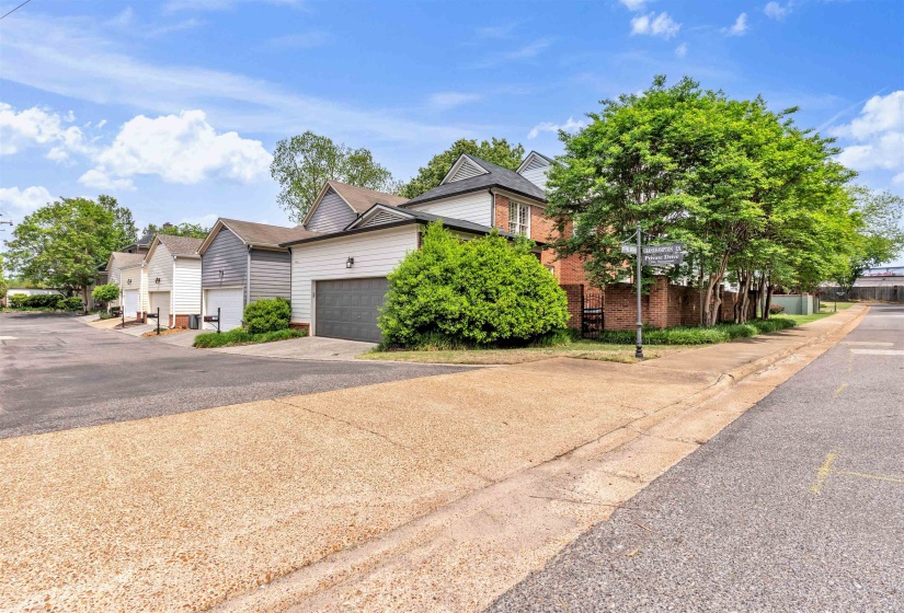 Brick and siding exterior with mature landscaping