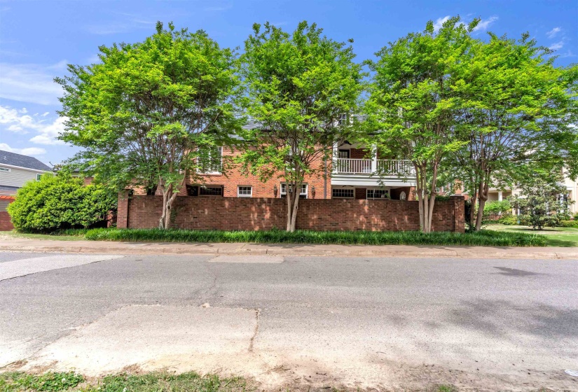 Brick exterior with a second-story balcony featuring white railings
