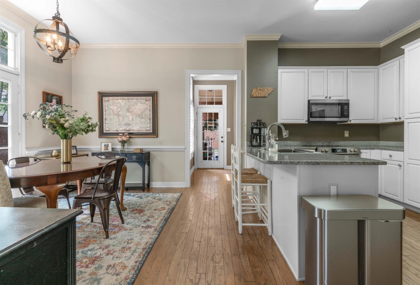 Open-concept kitchen and dining area featuring wood-finish flooring