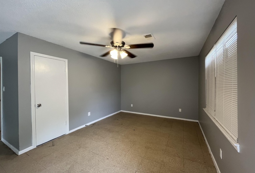 Unfurnished bedroom featuring baseboards and ceiling fan