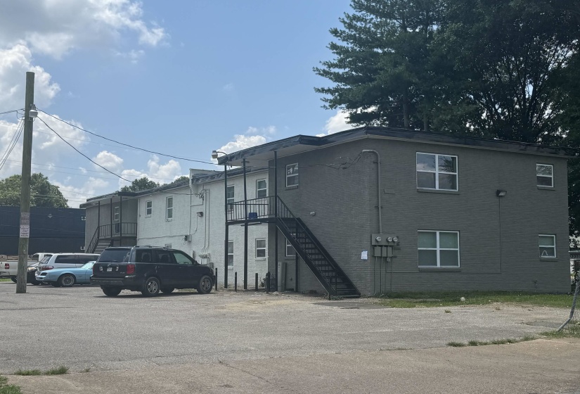 Multi-unit property featuring two-story brick construction with multiple window configurations