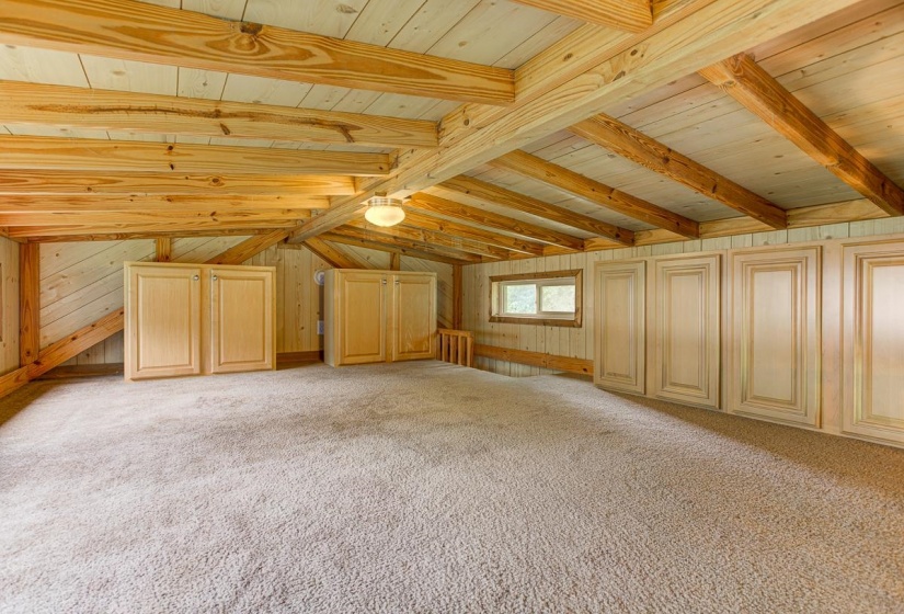 Vaulted wood-paneled ceiling with exposed beams