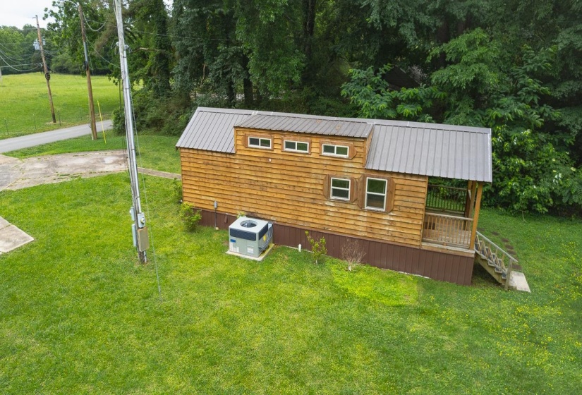 Wood-sided dwelling with a metal roof and an integrated covered porch