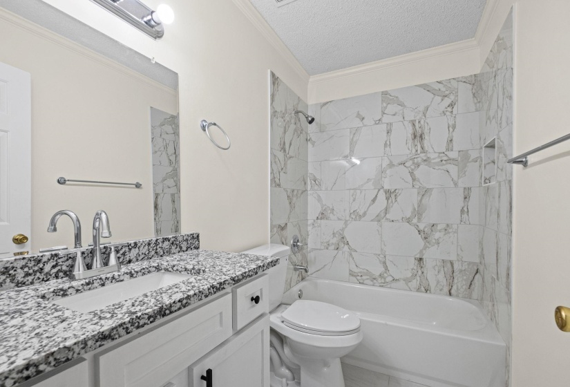 Bathroom featuring a white vanity with a granite countertop and integrated sink