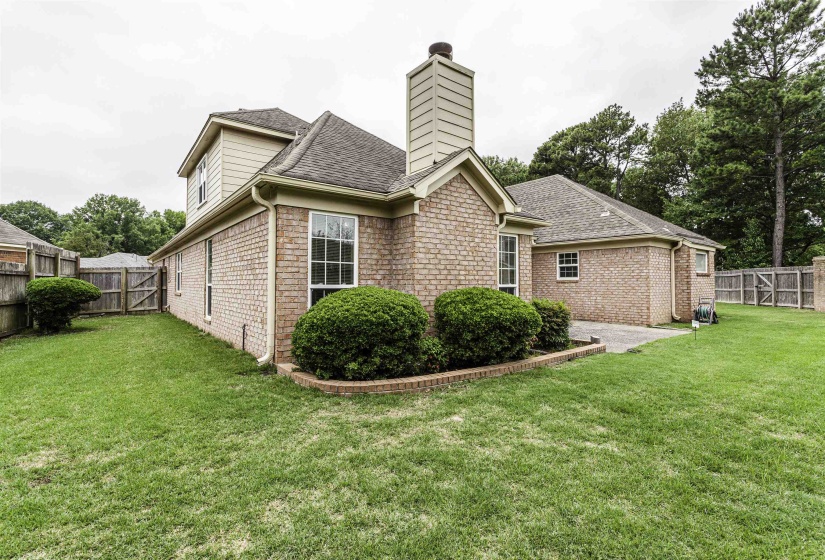 Brick exterior featuring a two-story design and a prominent chimney