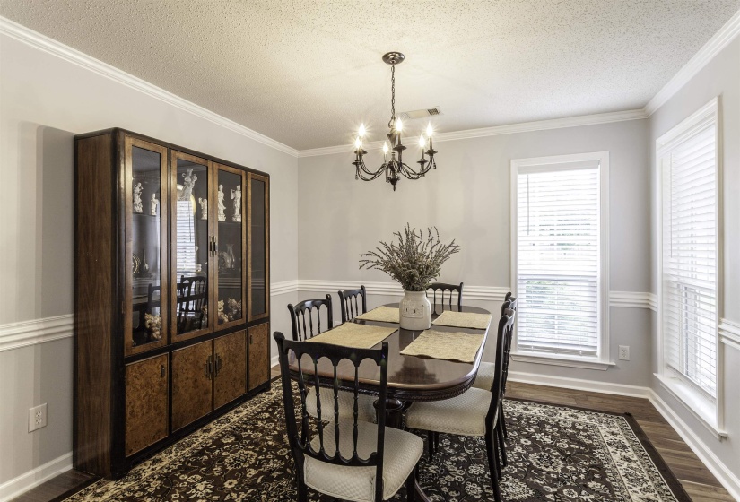 Dining area featuring wood-finish flooring and chair rail molding