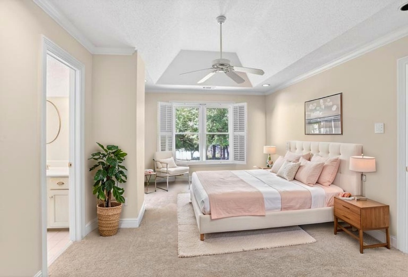 Additional primary bedroom upstairs with large walk in closet and your very own private bathroom. It also has a beautiful view of the lake. Virtual Staging in this room
