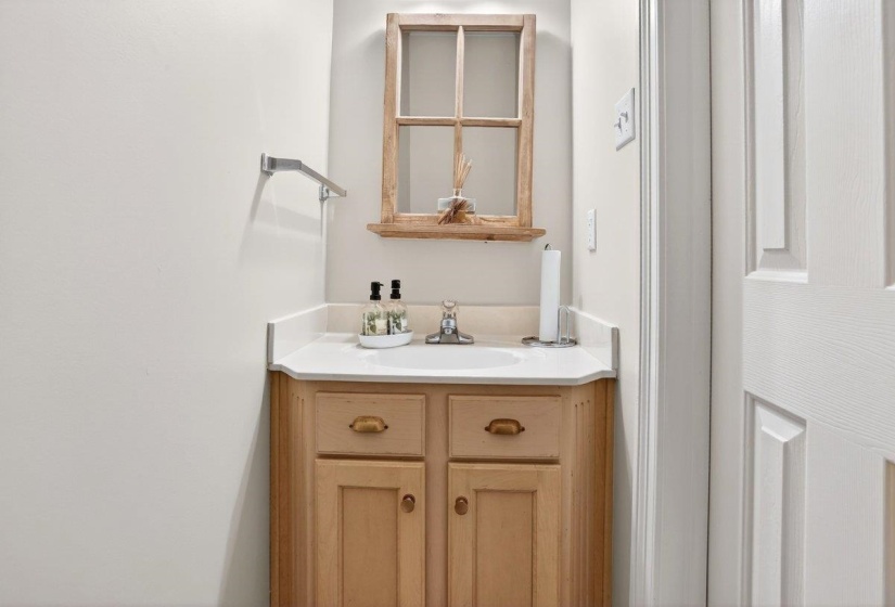 Half bath is located downstairs next to the laundry room area.