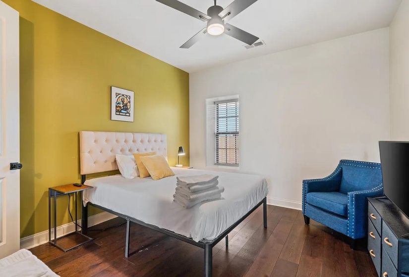 Bedroom featuring dark wood-type flooring and ceiling fan