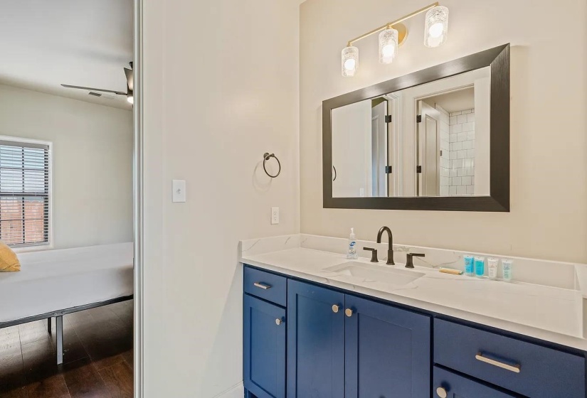 Bathroom with vanity, dark wood-type flooring, and a ceiling fan