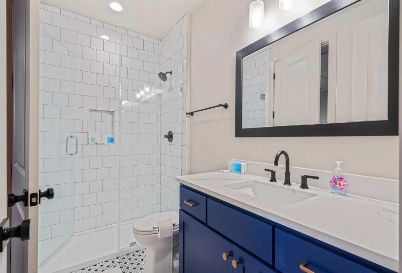 Bathroom with vanity, a stall shower, and recessed lighting