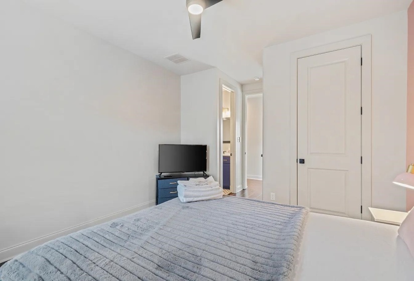Bedroom with ceiling fan and connected bathroom
