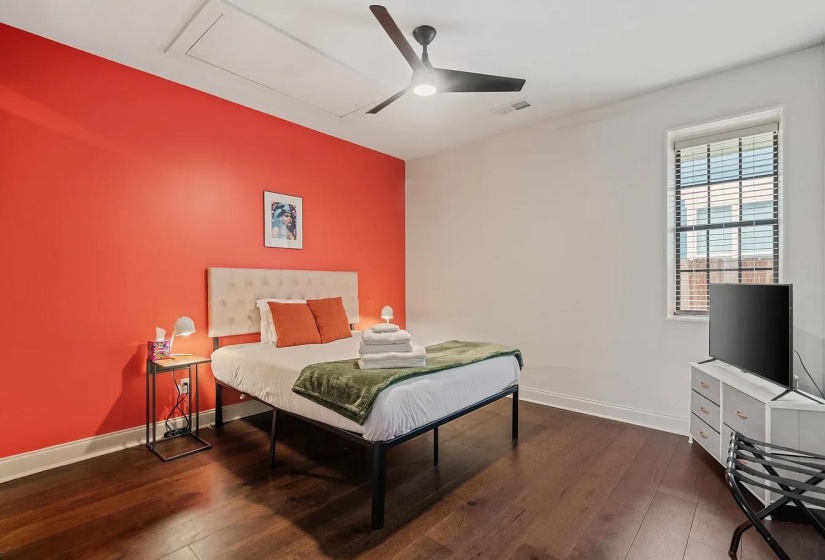 Bedroom with dark wood finished floors and a ceiling fan