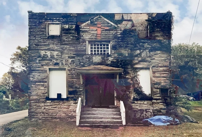 View of front of home with stone siding and entry steps