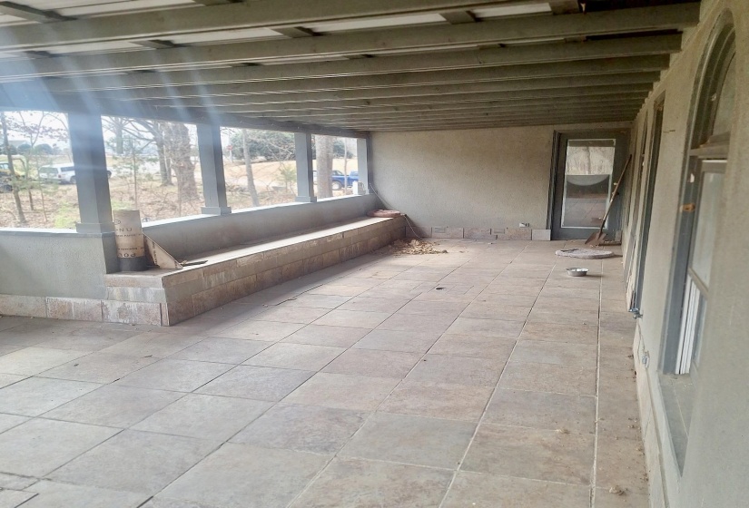 Unfurnished sunroom featuring a patio area