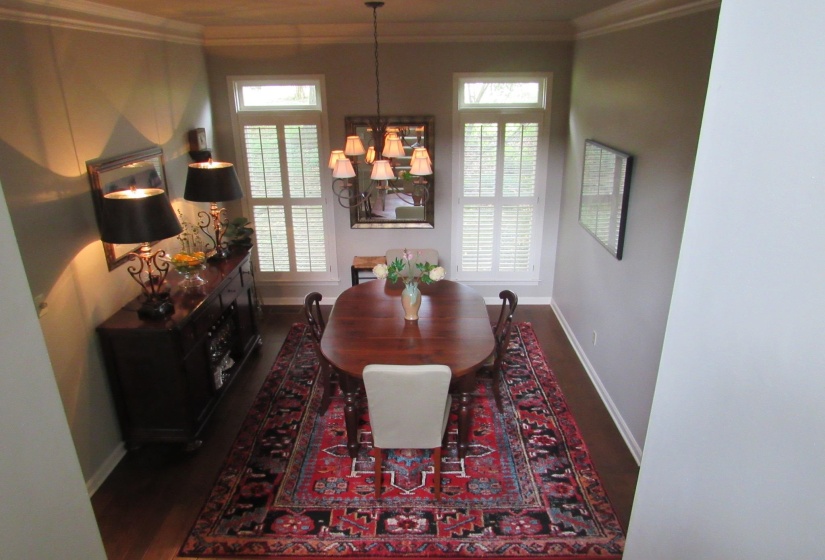 Formal dining area featuring rich wood-finish flooring