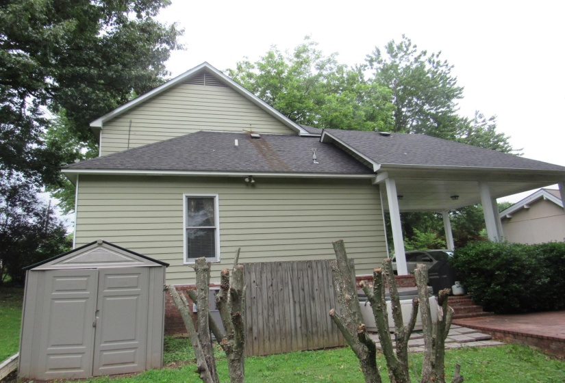 Light green horizontal siding with a dark asphalt shingle roof