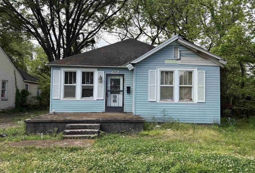 Light blue siding exterior featuring white window shutters