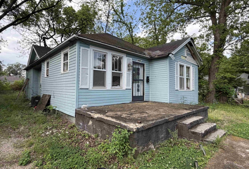 Light blue siding exterior with a dark asphalt shingle roof
