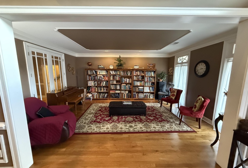 Living area featuring wood finished floors and ornamental molding