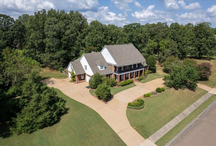 Aerial view of property and surrounding area with a forest