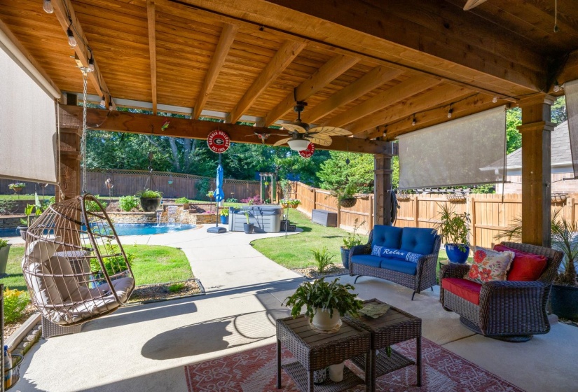 Covered patio featuring a wood-paneled ceiling, exposed beam structure, and recessed lighting