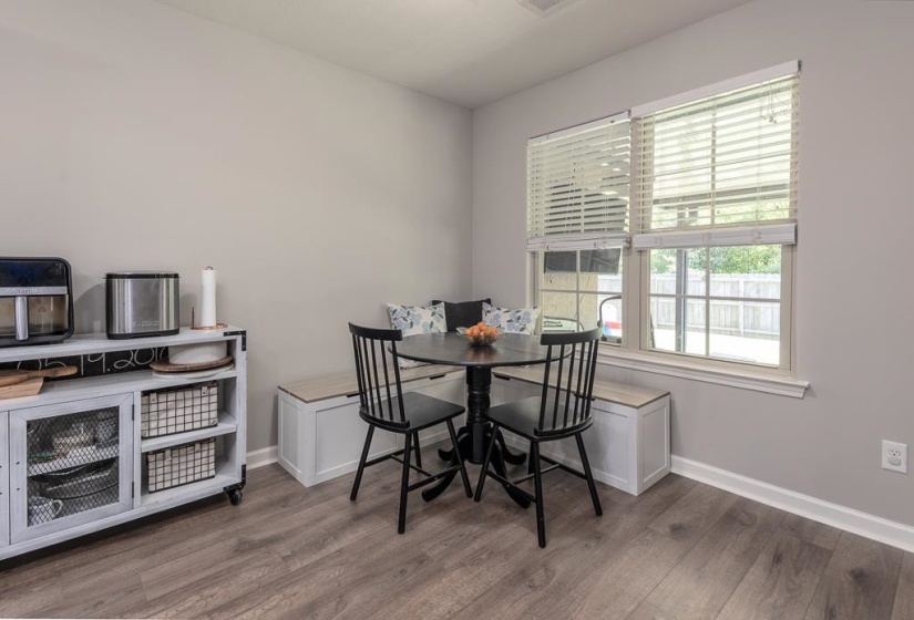 Dining area featuring a built-in bench seating arrangement with integrated storage