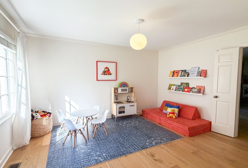 Light wood-finish flooring with white baseboards