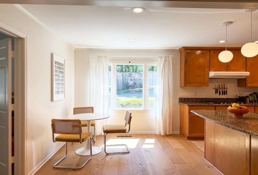 Light wood-finish flooring extending from the dining area into the kitchen