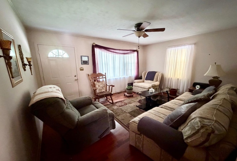Living area featuring a ceiling fan, recessed lighting, and multiple windows