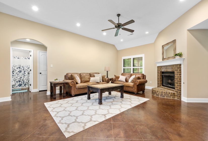 Spacious living area featuring high vaulted ceilings, recessed lighting, and a ceiling fan
