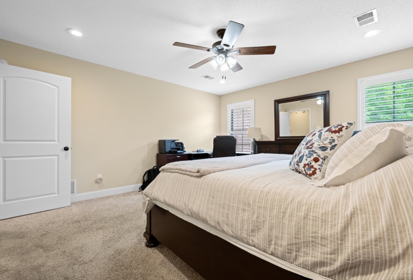 Carpeted bedroom featuring an arch-panel door, recessed lighting, and a ceiling fan